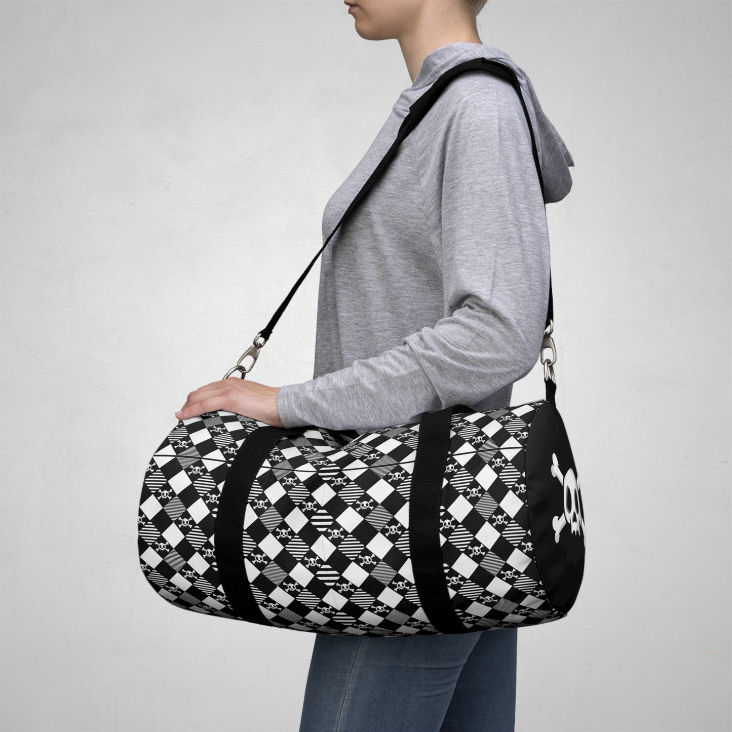 Black and White Diamond Pattern Skull and Crossbones Duffel Bag side view person heading on vacation catching a plane with their carry on luggage