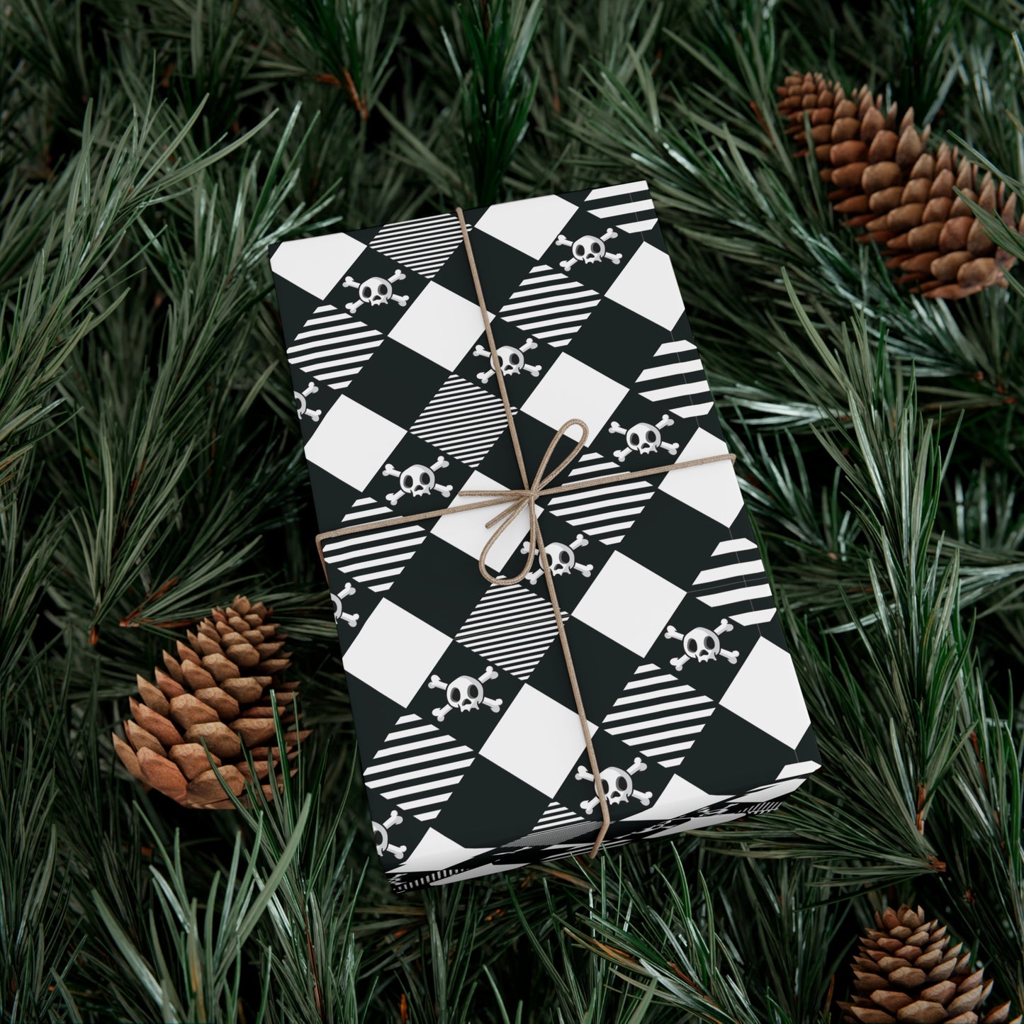 Black and white diamond pattern skull and crossbones wrapping paper on a gift for christmas in a tree with pinecones