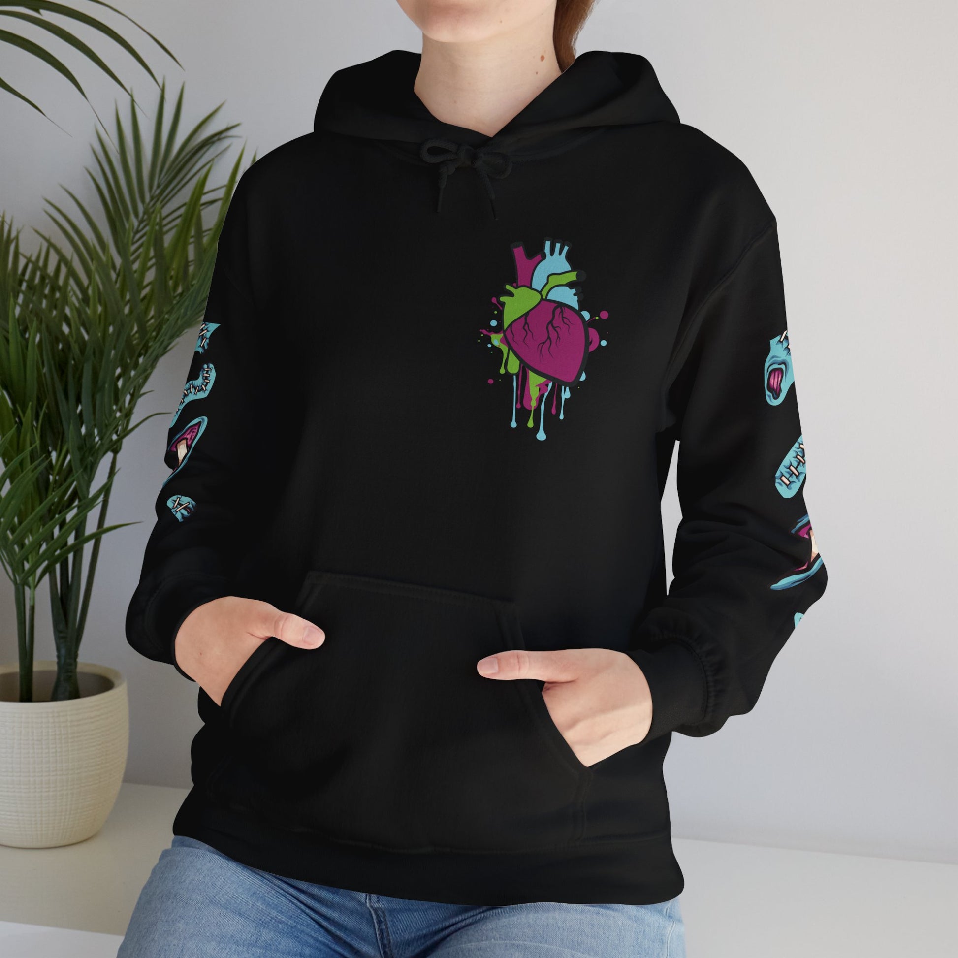 Black hoodie with colorful graffiti zombie heart in a dripping design, ideal for Halloween or casual streetwear.